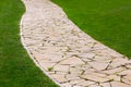 Footpath from different pieces of stone paved.