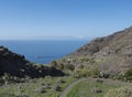 Footpath of hiking trail Tasartico to Playa GuiGui beach, Barranco de Guigui Grande ravine with cacti, succulents and