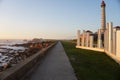 Footpath next to the A Linha do Mar on a rocky coast under a blue sky