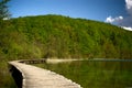 Footpath over clear mountain lake in national park Royalty Free Stock Photo