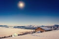 Footpath in winter mountains leading to the chalets