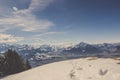 Footprint and animal tracks on snow with mountain range and blue sky background Royalty Free Stock Photo