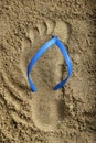 Footprint Blue Rubber Beach Flip Flops on Sand Royalty Free Stock Photo