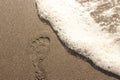 Footprint on brown sand beach