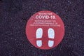 Footprint floor sticker, foot steps in circle, keep distance waiting in line, stand here sign, coronavirus or Covid-19