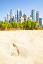 Footprint in the sand and Dubai skyline, UAE Royalty Free Stock Photo