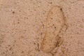 Footprint of shoes on wet sand texture. View from above. The concept is the beginning of a path, a trip, a step to something Royalty Free Stock Photo