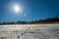 Footprint on snow and blue sky with Sun flare Royalty Free Stock Photo