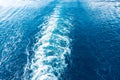 Footprint on the water from the ship. White wave on blue water. Blue sea water. Water and sky Royalty Free Stock Photo