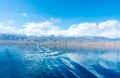 Footprint on the water from the ship. White wave on blue water. Blue sea water. Water and sky Royalty Free Stock Photo