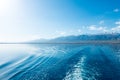 Footprint on the water from the ship. White wave on blue water. Blue sea water. Water and sky Royalty Free Stock Photo