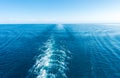 Footprint on the water from the ship. White wave on blue water. Blue sea water. Water and sky Royalty Free Stock Photo
