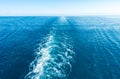 Footprint on the water from the ship. White wave on blue water. Blue sea water. Water and sky Royalty Free Stock Photo