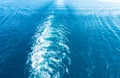 Footprint on the water from the ship. White wave on blue water. Blue sea water. Water and sky Royalty Free Stock Photo