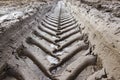 Footprint of wheel tread on the ground road. The trail from the tread of trucks wheels. Car tire tread imprint on sand, background Royalty Free Stock Photo