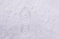 Footprint in the white snow. Overhead view