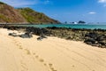 Footprints on a beautiful tropical beach next to a clear, warm ocean Royalty Free Stock Photo