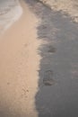 Footprints on black and white wet sand. Olchon island, Lake Baikal Royalty Free Stock Photo