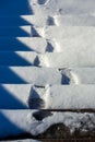 Footprints of boots on snowy steps