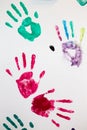 Footprints of children`s palms in colored paint. Children`s hands on the wall.