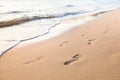 Footprints of couple walking on the beach
