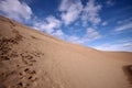 Footprints in desert under blue cloudy sky Royalty Free Stock Photo