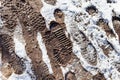 Footprints on dirty road covered by snow Royalty Free Stock Photo