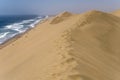 footprints on dune edge at Atlantic shore near Sandwich Harbour, Namibia Royalty Free Stock Photo