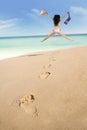 Footprints and excited woman jumping Royalty Free Stock Photo