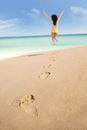 Footprints and excited woman jumping 1 Royalty Free Stock Photo