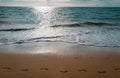 Footprints at golden sand, footsteps. Beach with golden sand, turquoise ocean water. Panoramic sea view. Natural