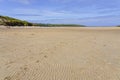 Footprints lead down the rippled sands of Crantock beach Royalty Free Stock Photo