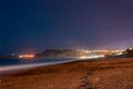 Footprints leading to the little foggy Tono`s Bay or Baia del Tono. Silk effect and some stars in the background. Sicily, Italy