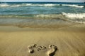 Footprints in love couple in the sand on the beach