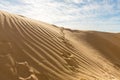 Footprints  of a man rising up a sand dune near the ruins of the Roman aqueduct in Caesarea, in northern Israel Royalty Free Stock Photo