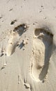 Footprints of man and woman on white sand by the beach. Couples trip. Royalty Free Stock Photo