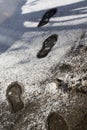 Footprints in melting snow. Snow texture with shoeprints.