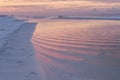 Footprints in the sand on a beach at sunrise