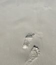 Footprints in the sand on the beach, closeup of photo Royalty Free Stock Photo