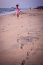 Footprints in the sand from children`s feet.