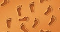 Footprints in the sand create a repeating pattern on a textured background. The Royalty Free Stock Photo