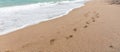 Footprints in the sand on a deserted beach Royalty Free Stock Photo