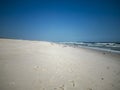 Footprints in the sand of Gilgo Beach with a dark blue sky Royalty Free Stock Photo