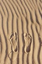 Footprints in the sand. Imprint of man`s foot on the sand on the beach