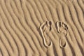 Footprints in the sand. Imprint of man`s foot on the sand on the beach