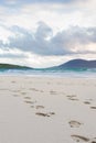 Footprints in the sand, turquise water and impressive skyes, Luskentyre, Isle of Harris, Scotland Royalty Free Stock Photo