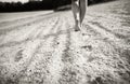 Footprints on the sand with walking girl on background Royalty Free Stock Photo