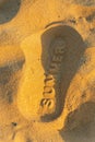 Footprints in the sand with the word summer