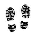 Footprints and shoeprints icons in black and white showing bare feet and the imprint of the soles with the differing Royalty Free Stock Photo