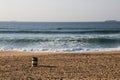 Footprints on the Shoreline with a Garbage Bin Royalty Free Stock Photo